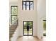 Spacious foyer with soaring ceilings, sleek staircase, herringbone flooring, and a stylish black front door at 1501 Harts Mill Ne Rd, Brookhaven, GA 30319