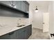 Modern laundry room featuring stylish cabinets, a sink, and unique flooring at 1501 Harts Mill Ne Rd, Brookhaven, GA 30319