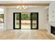 Open living room featuring hardwood floors, modern chandelier, and access to the backyard through sliding glass doors at 1501 Harts Mill Ne Rd, Brookhaven, GA 30319