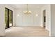 Open-concept living room with light hardwood floors, modern lighting, and large window offering natural light at 1501 Harts Mill Ne Rd, Brookhaven, GA 30319