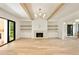 Bright living room with hardwood floors, fireplace, and built-in shelving and cabinets, under wood ceiling beams at 1501 Harts Mill Ne Rd, Brookhaven, GA 30319