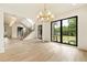 Bright and airy living room with herringbone floors, large black frame windows, and elegant light fixtures at 1501 Harts Mill Ne Rd, Brookhaven, GA 30319
