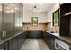 Mudroom has dark cabinets, herringbone tile, and modern light fixture at 1501 Harts Mill Ne Rd, Brookhaven, GA 30319