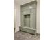 Mudroom features custom cabinets with seat and herringbone tile flooring for added style and functionality at 1501 Harts Mill Ne Rd, Brookhaven, GA 30319