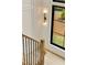 Bright staircase features hardwood steps, sleek black railings, and a large window for natural light at 1501 Harts Mill Ne Rd, Brookhaven, GA 30319