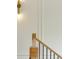 Bright staircase featuring wooden handrail with black metal spindles and modern sconce lighting at 1501 Harts Mill Ne Rd, Brookhaven, GA 30319