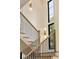 Staircase features hardwood steps, black metal railings, and modern lighting fixtures, creating a bright space at 1501 Harts Mill Ne Rd, Brookhaven, GA 30319