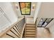 Staircase features hardwood steps, modern railings, and natural light from skylight and side windows at 1501 Harts Mill Ne Rd, Brookhaven, GA 30319