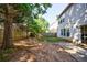 Private backyard with a mix of grass and mulched areas, surrounded by a wooden fence at 3226 Saville Sw St, Atlanta, GA 30331