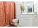 Well-lit bathroom with shower/tub combo, white vanity, and decorative curtain at 3226 Saville Sw St, Atlanta, GA 30331