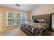 Bright bedroom featuring a tufted headboard bed and large windows with natural light at 3226 Saville Sw St, Atlanta, GA 30331