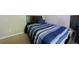 Standard bedroom with bed, dark wood headboard and blue striped comforter at 3226 Saville Sw St, Atlanta, GA 30331