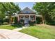 Community clubhouse featuring brick facade, white columns, and manicured landscaping at 3226 Saville Sw St, Atlanta, GA 30331