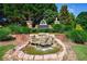 Stone water feature at the entrance of the 'Princeton Lakes' community, surrounded by lush landscaping at 3226 Saville Sw St, Atlanta, GA 30331