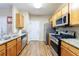 Kitchen features stainless steel appliances, granite countertops, and light wood cabinetry at 3226 Saville Sw St, Atlanta, GA 30331