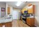 Kitchen with granite countertops, stainless steel appliances, and light wood cabinetry at 3226 Saville Sw St, Atlanta, GA 30331