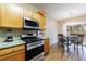 Modern kitchen with stainless steel range, granite counters and adjacent dining area at 3226 Saville Sw St, Atlanta, GA 30331