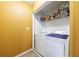 Dedicated laundry room area with washer, dryer, and storage shelves provides convenience at 3226 Saville Sw St, Atlanta, GA 30331