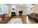 Bright living room with fireplace, hardwood floors, and comfortable seating arrangement at 3226 Saville Sw St, Atlanta, GA 30331