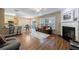 Open-concept living room with a fireplace, a dining area, and kitchen access at 3226 Saville Sw St, Atlanta, GA 30331
