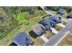 An aerial view of neighborhood homes shows a pond in the background at 5530 Bower Pl, Cumming, GA 30028
