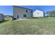 Backyard featuring a large lawn, a concrete patio, and the home's exterior at 5530 Bower Pl, Cumming, GA 30028
