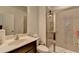 Well-lit bathroom with a glass-enclosed shower, stylish vanity, and tiled floors at 5530 Bower Pl, Cumming, GA 30028