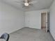 Bright bedroom with light gray carpet, neutral walls, fan, and doorways to other rooms at 5530 Bower Pl, Cumming, GA 30028