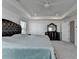 Spacious bedroom with a tray ceiling with ceiling fan, carpet, and a large bed next to a dark dresser at 5530 Bower Pl, Cumming, GA 30028