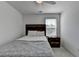 Bedroom featuring natural light and modern furnishings including a wooden bed frame and nightstand at 5530 Bower Pl, Cumming, GA 30028
