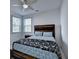 Cozy bedroom with natural lighting, a ceiling fan, and a wood-framed bed at 5530 Bower Pl, Cumming, GA 30028