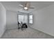 Bright room featuring neutral walls, carpet, fan, and windows providing lots of natural light at 5530 Bower Pl, Cumming, GA 30028