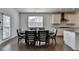 Cozy dining area with modern table and chairs situated near a window for ample natural light at 5530 Bower Pl, Cumming, GA 30028