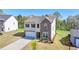 Charming two-story home with a two-car garage, stone facade, and manicured landscaping at 5530 Bower Pl, Cumming, GA 30028