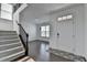 Open foyer with hardwood floors, stairway, and white walls creating a bright and welcoming space at 5530 Bower Pl, Cumming, GA 30028