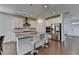 Modern kitchen with stainless steel appliances, center island with bar stools and open floor plan at 5530 Bower Pl, Cumming, GA 30028