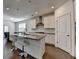 Bright, open kitchen boasts a large island with bar seating and stainless appliances at 5530 Bower Pl, Cumming, GA 30028
