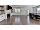 Open-concept living and dining area featuring hardwood floors, fireplace, and built-in cabinets at 5530 Bower Pl, Cumming, GA 30028