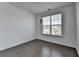 Cozy living room with hardwood floors, large window letting in natural light, and neutral paint at 5530 Bower Pl, Cumming, GA 30028