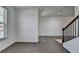 Open-concept home with hardwood floors and stairway in the entry area, with ample natural light at 5530 Bower Pl, Cumming, GA 30028
