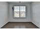 Neutral living room features hardwood floors, large window letting in natural light, and white walls at 5530 Bower Pl, Cumming, GA 30028
