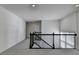 A versatile loft space, featuring neutral paint and a view of the staircase and natural light at 5530 Bower Pl, Cumming, GA 30028