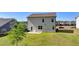 A lush green yard can be seen behind the home with the patio at 5530 Bower Pl, Cumming, GA 30028