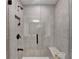 Shower featuring a tiled wall, built-in shelving, a shower head, and a shower bench at 5530 Bower Pl, Cumming, GA 30028