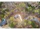 Aerial view of property line; a blue two-story home surrounded by lush greenery with street access at 7636 Chestnut Hill Rd, Cumming, GA 30041