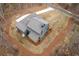Aerial view of property line; the back of a gray and blue two-story home with a deck surrounded by greenery at 7636 Chestnut Hill Rd, Cumming, GA 30041
