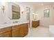 Bright bathroom boasts double vanity with marble countertop, and a view of the natural wooded back yard at 7636 Chestnut Hill Rd, Cumming, GA 30041