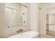 Bright bathroom features a soaking tub, separate shower with glass enclosure, and a view to the walk-in closet at 7636 Chestnut Hill Rd, Cumming, GA 30041