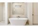 Luxurious bathroom with a freestanding tub and bright tile at 7636 Chestnut Hill Rd, Cumming, GA 30041