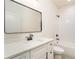 Modern bathroom with a sleek vanity, framed mirror, and tiled shower/tub combination at 7636 Chestnut Hill Rd, Cumming, GA 30041